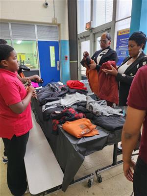 students receiving hoodies